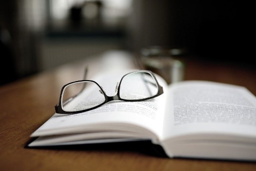 Bild mit einem Buch und einer Brille zu Infinitivsätzen im Deutschen zu und zum